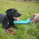 Travel dog water bottle flip bowl showing drinking mechanism