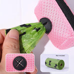 Dog poop bag dispenser clipped to leash handle in use